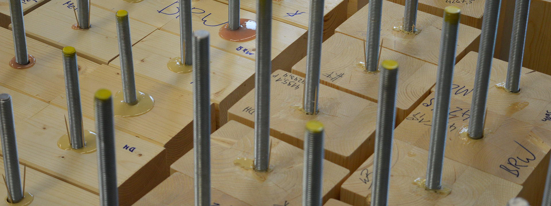 Threaded rods glued into wooden cubes.